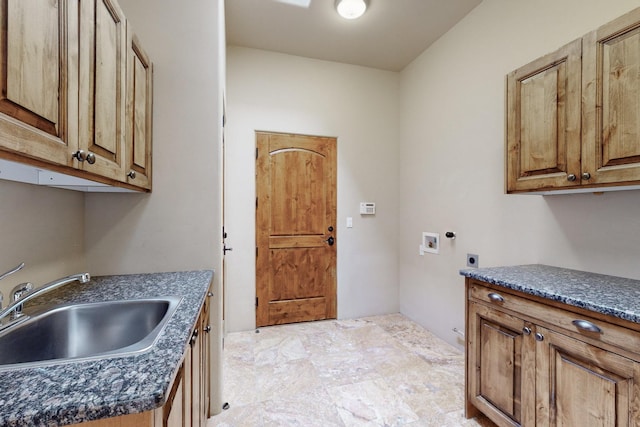 washroom featuring washer hookup, hookup for an electric dryer, a sink, and cabinet space