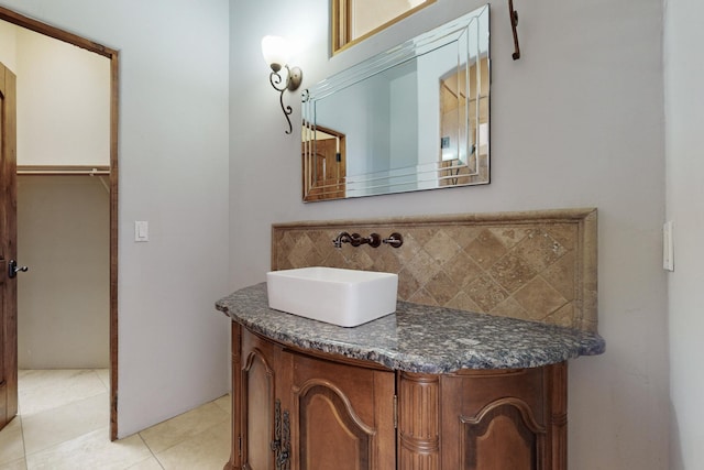 bathroom with tile patterned flooring, vanity, and decorative backsplash