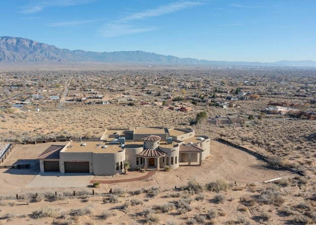 drone / aerial view with view of desert and a mountain view