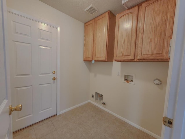 laundry area featuring cabinets, hookup for a washing machine, hookup for an electric dryer, gas dryer hookup, and light tile patterned flooring