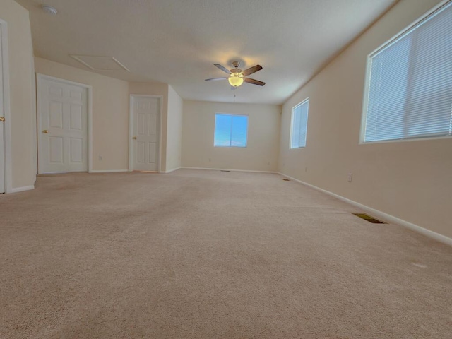 carpeted empty room featuring ceiling fan