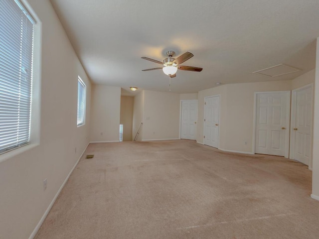 spare room with light carpet and ceiling fan