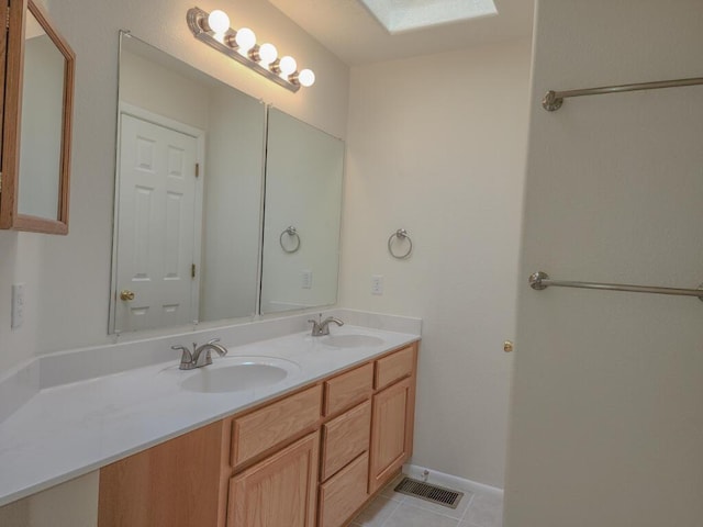 bathroom with tile patterned flooring and vanity