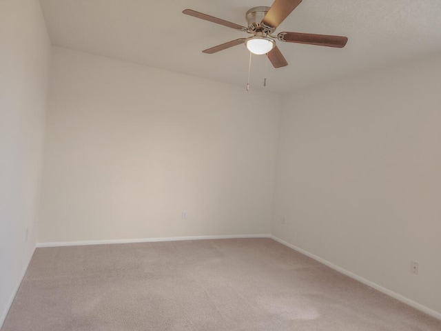 unfurnished room featuring ceiling fan and carpet floors