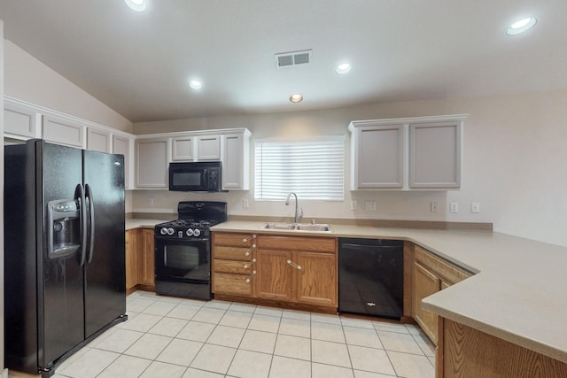 kitchen featuring white cabinets, sink, vaulted ceiling, and black appliances