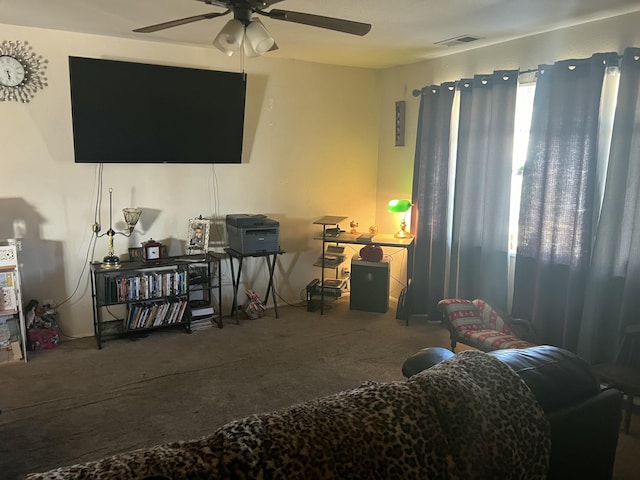 living room with ceiling fan and carpet