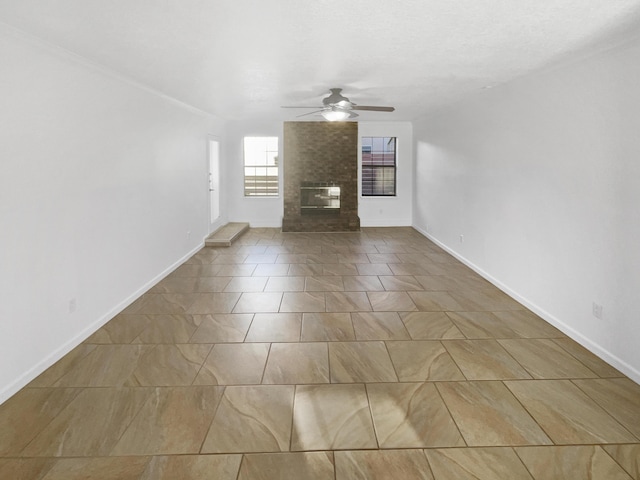 unfurnished living room featuring a brick fireplace and ceiling fan