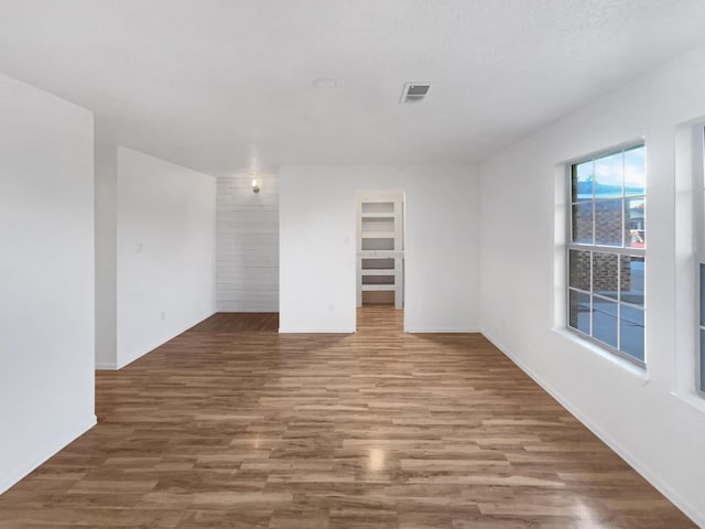 spare room with wood-type flooring