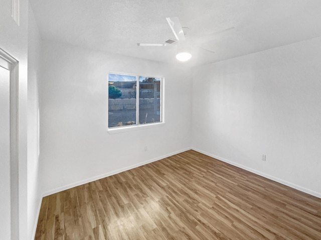 empty room featuring ceiling fan and wood-type flooring