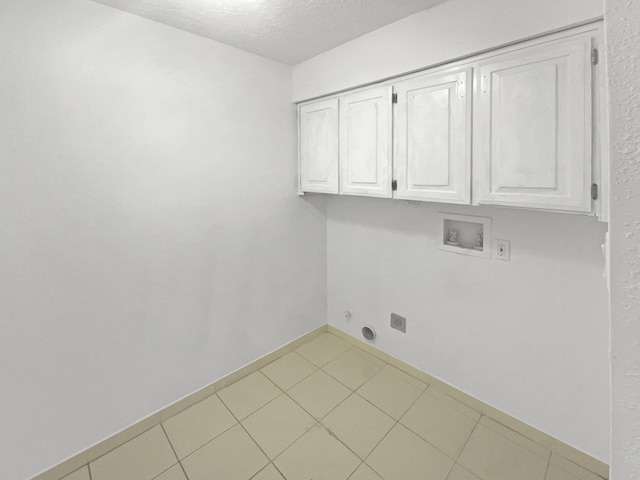 laundry room with cabinets, hookup for a washing machine, a textured ceiling, and hookup for an electric dryer