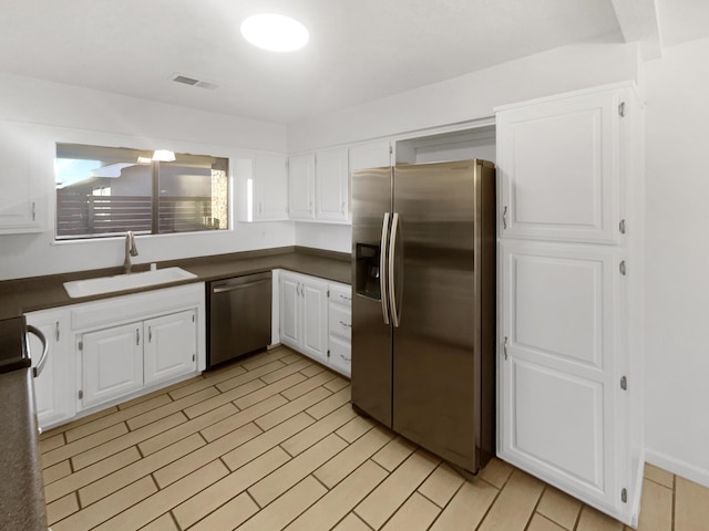 kitchen with white cabinets, sink, and stainless steel appliances