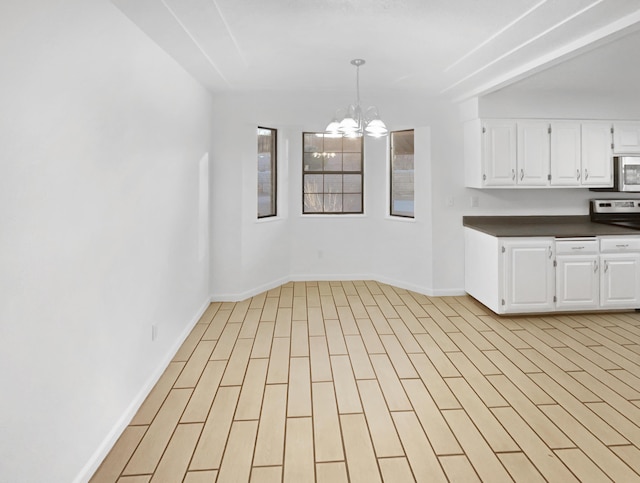 unfurnished dining area featuring a notable chandelier