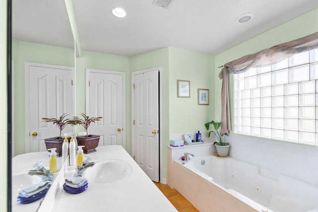 bathroom featuring a washtub and vanity