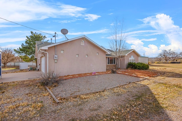 back of property with a garage