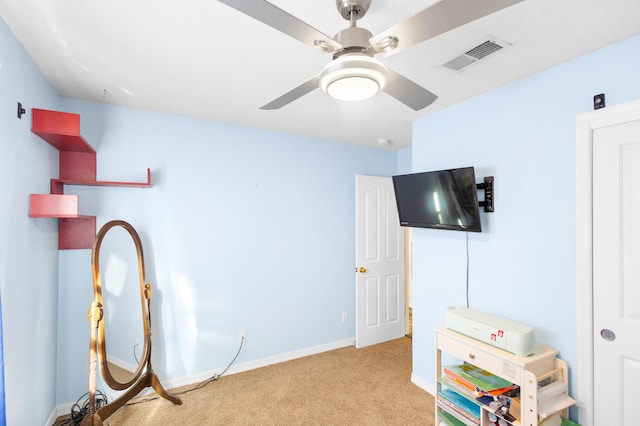 interior space featuring light carpet and ceiling fan