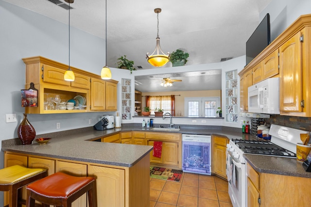 kitchen featuring ceiling fan, sink, kitchen peninsula, decorative light fixtures, and white appliances