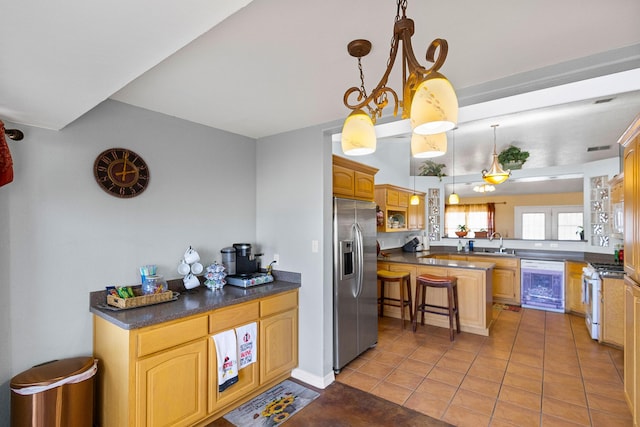 kitchen with white appliances, an inviting chandelier, sink, wine cooler, and a kitchen bar