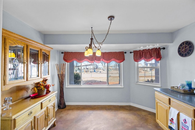 carpeted dining room featuring a chandelier