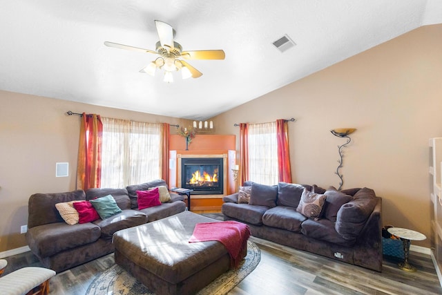 living room featuring hardwood / wood-style flooring, vaulted ceiling, and ceiling fan