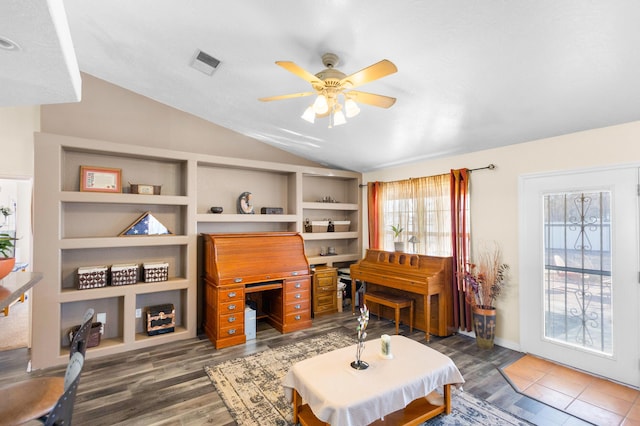 living room featuring dark hardwood / wood-style floors, vaulted ceiling, and ceiling fan