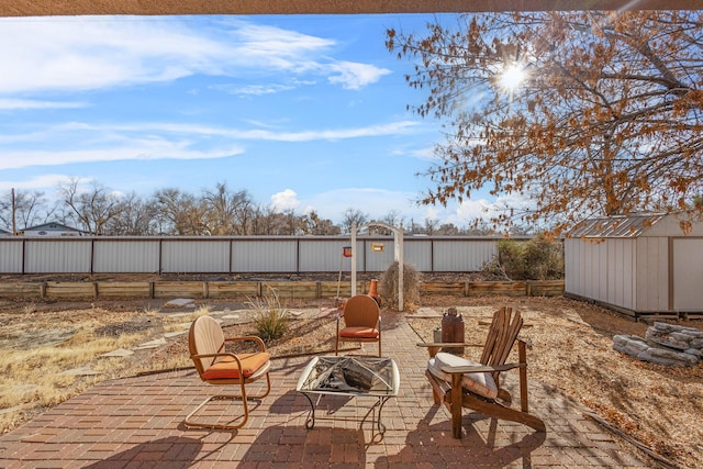 view of patio / terrace with a storage unit and an outdoor fire pit