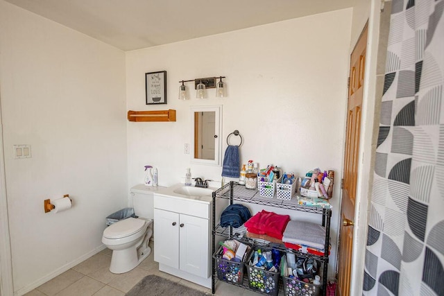 bathroom with tile patterned floors, vanity, and toilet