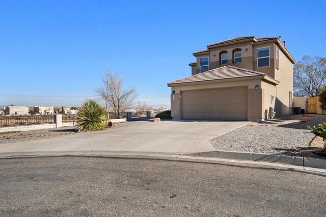 view of front of house featuring cooling unit and a garage