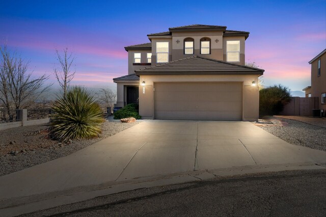 view of front of house with central AC and a garage