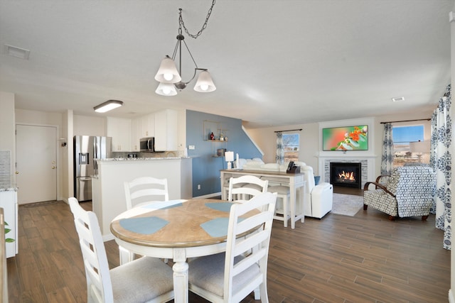 dining space featuring a chandelier and dark hardwood / wood-style flooring