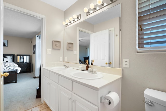 bathroom featuring vanity, ceiling fan, and toilet