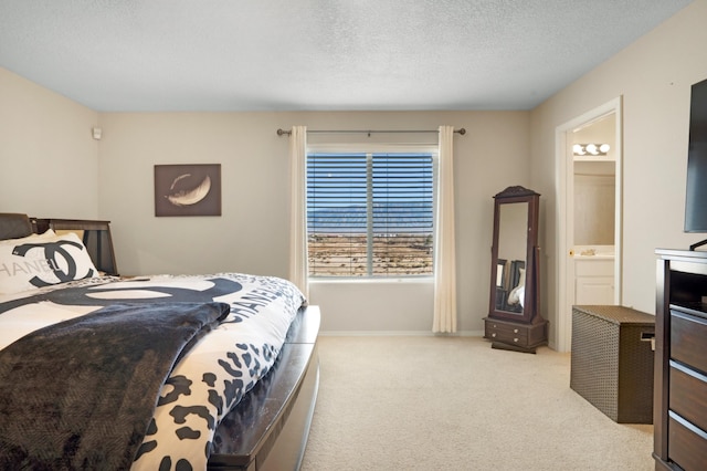 carpeted bedroom with connected bathroom and a textured ceiling