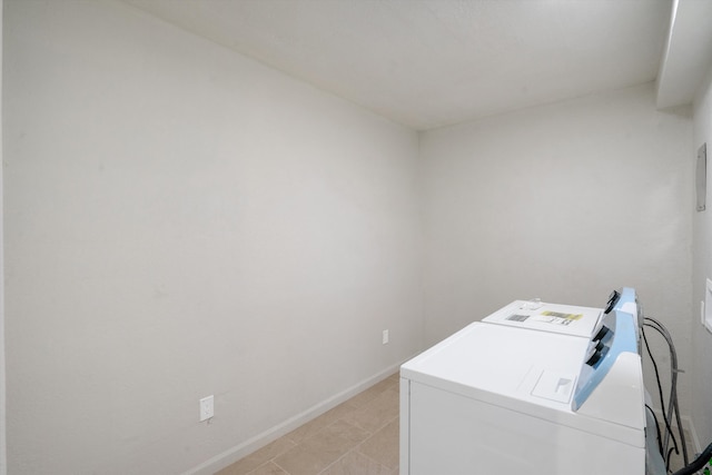 washroom featuring washer and dryer and light tile patterned flooring