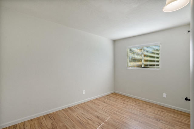 empty room with light hardwood / wood-style floors