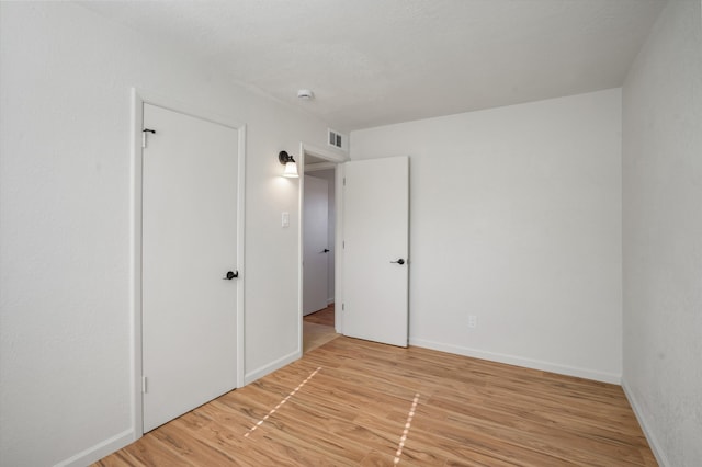 unfurnished bedroom featuring light wood-type flooring