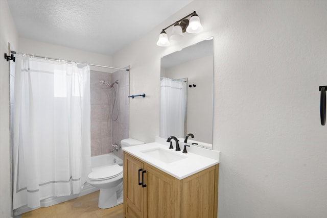 full bathroom with vanity, toilet, shower / tub combo, and a textured ceiling