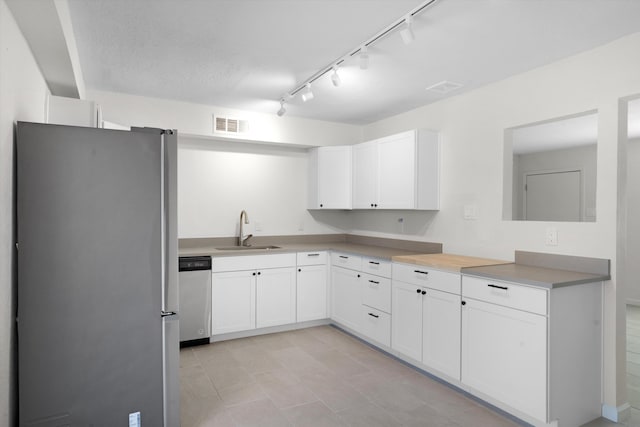 kitchen with white cabinetry, stainless steel appliances, rail lighting, and sink