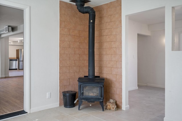 room details with stainless steel appliances and a wood stove