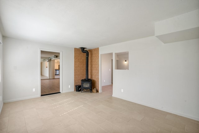 unfurnished living room featuring a wood stove