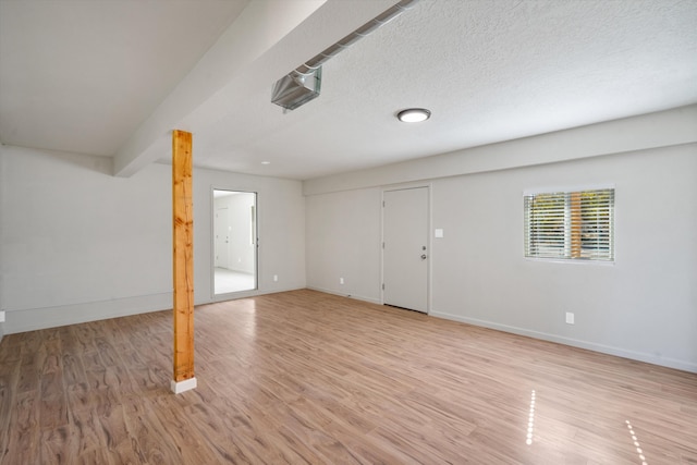 basement with a textured ceiling and light wood-type flooring