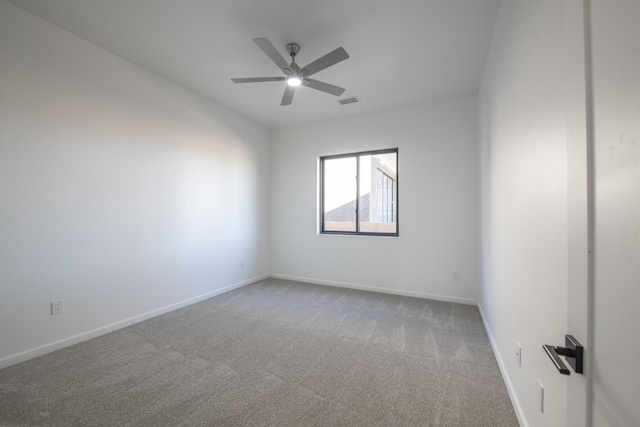 spare room featuring carpet flooring and ceiling fan