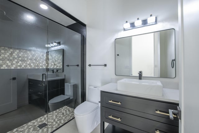 bathroom with tile patterned flooring, vanity, an enclosed shower, and toilet