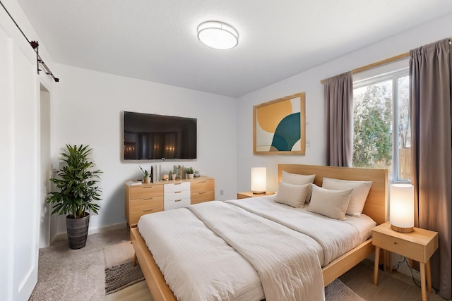 carpeted bedroom with a barn door