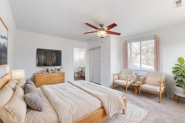 carpeted bedroom featuring ensuite bathroom and ceiling fan