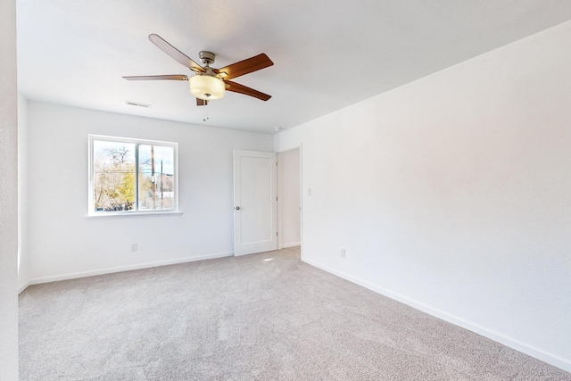 spare room with carpet floors and ceiling fan