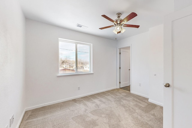 carpeted empty room featuring ceiling fan