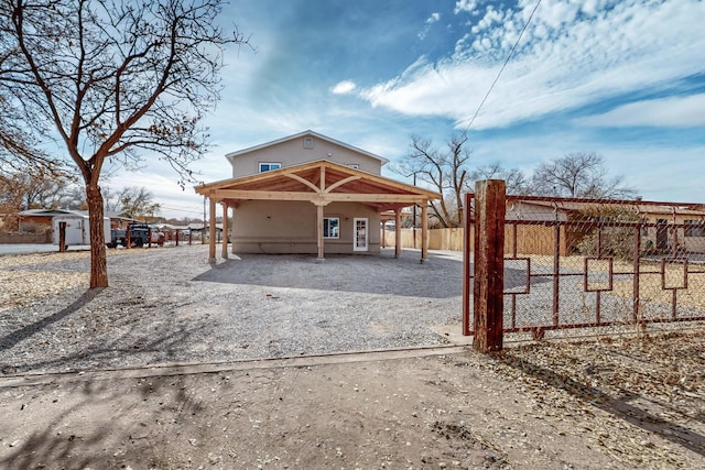 back of house featuring a storage shed