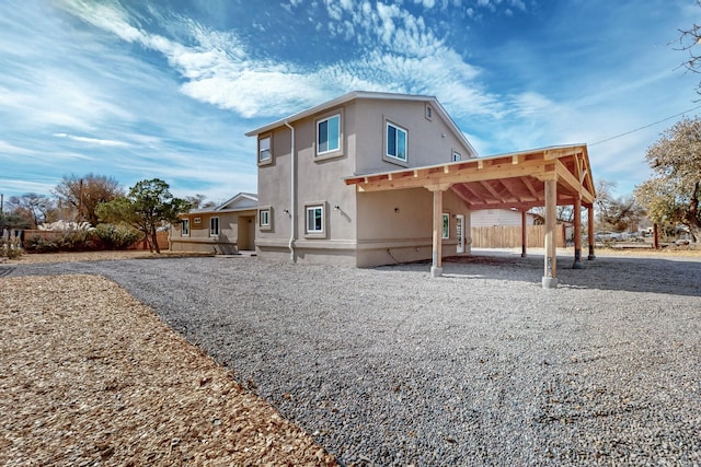 rear view of house featuring a carport