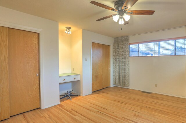 unfurnished bedroom with ceiling fan and light wood-type flooring