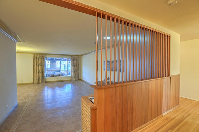 corridor featuring wood-type flooring and crown molding