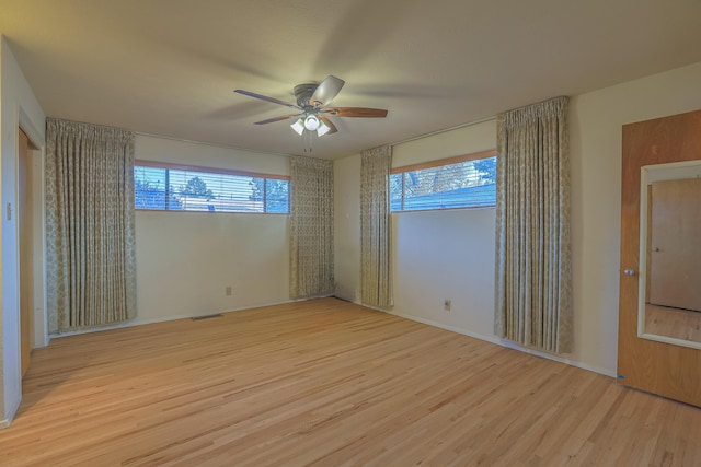 unfurnished bedroom with multiple windows, ceiling fan, and light hardwood / wood-style floors